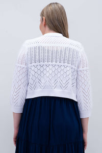 Back view of white cropped knit sweater with geometric pattern