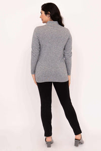Back view of model in light grey mock neck sweater and black pants