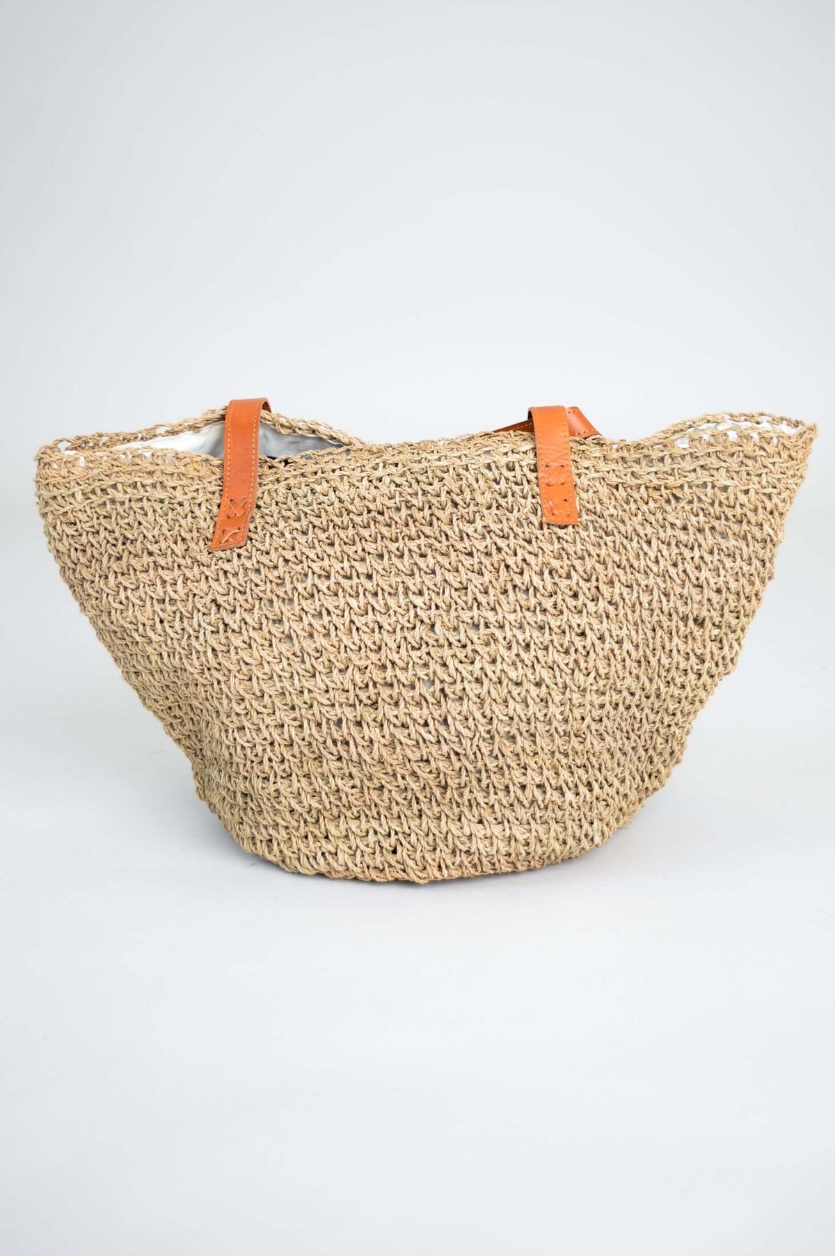 Back view of the hand woven rattan bag with leather handles