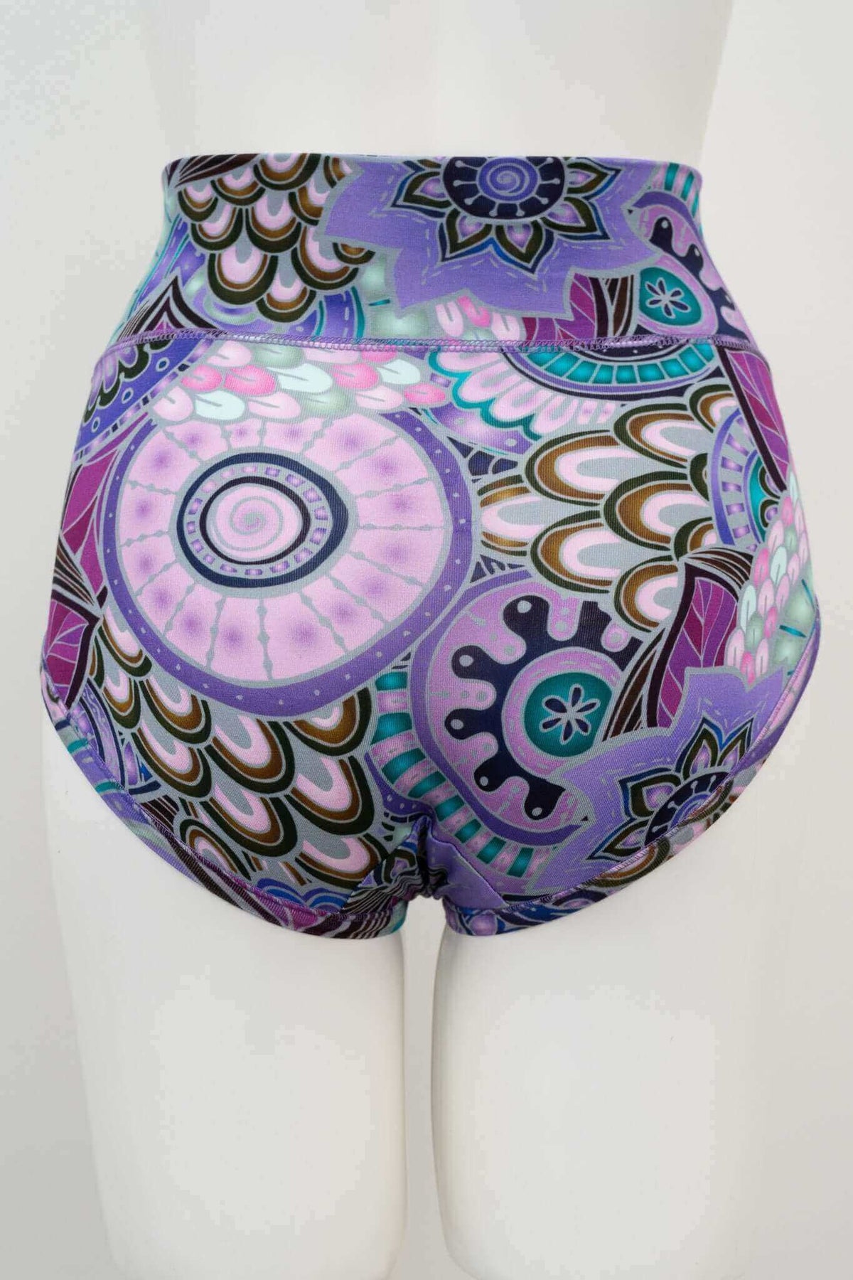 Back view of high-waisted brief featuring bold mandala print in purple, teal, and pink