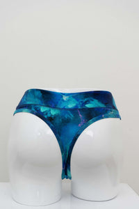 Back view of high rise blue watercolor bamboo thong on a mannequin