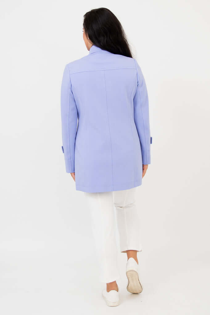Back view of woman wearing a light blue tulip jacket
