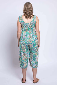 Back view of model in wide leg sleeveless jumpsuit with green paisley print