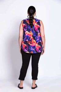Back view of model wearing bright multicolor sleeveless top and slim fit black pants