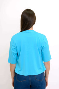 Back view of the bright blue cropped open-front jacket showing the sleeve and hem details
