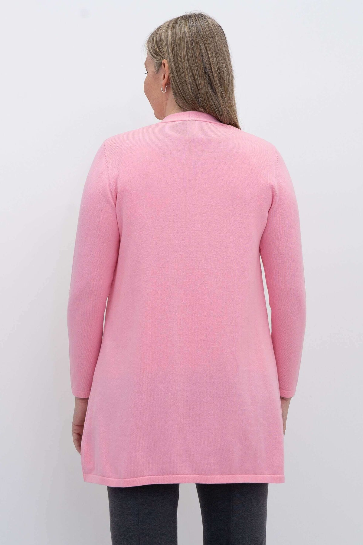 Back view of a woman wearing a pink open-front cotton cardigan