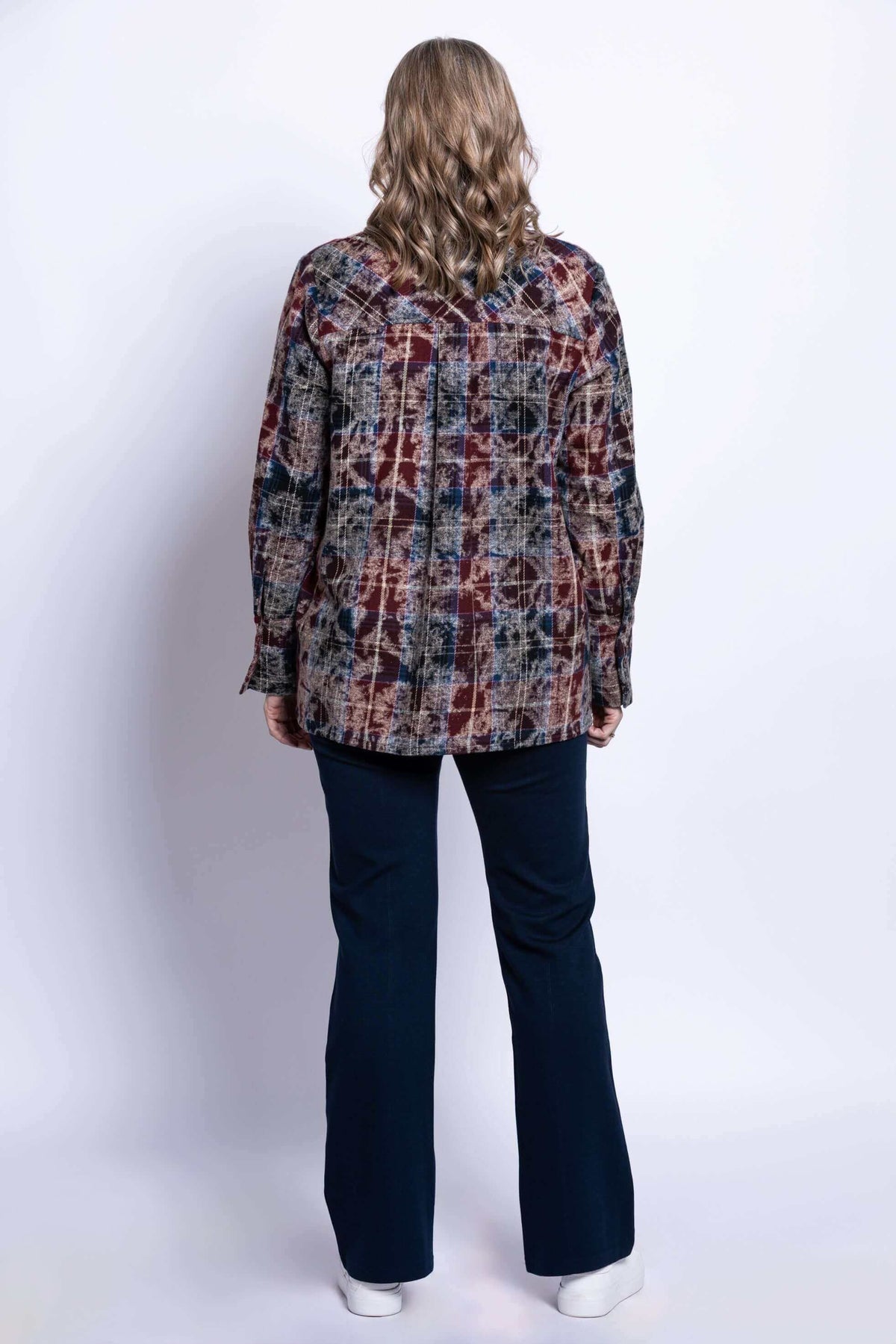 Back view of a woman wearing a long sleeve multi plaid cotton jacket displaying clean shoulder fit.