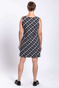 Back view of woman wearing sleeveless black and white plaid shift dress
