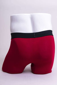 Back view of red bamboo boxer briefs with black waistband on mannequin