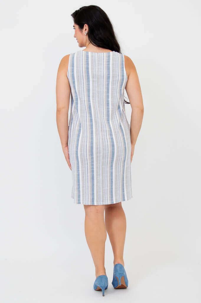 Back view of a woman wearing a blue and white striped sleeveless shift dress