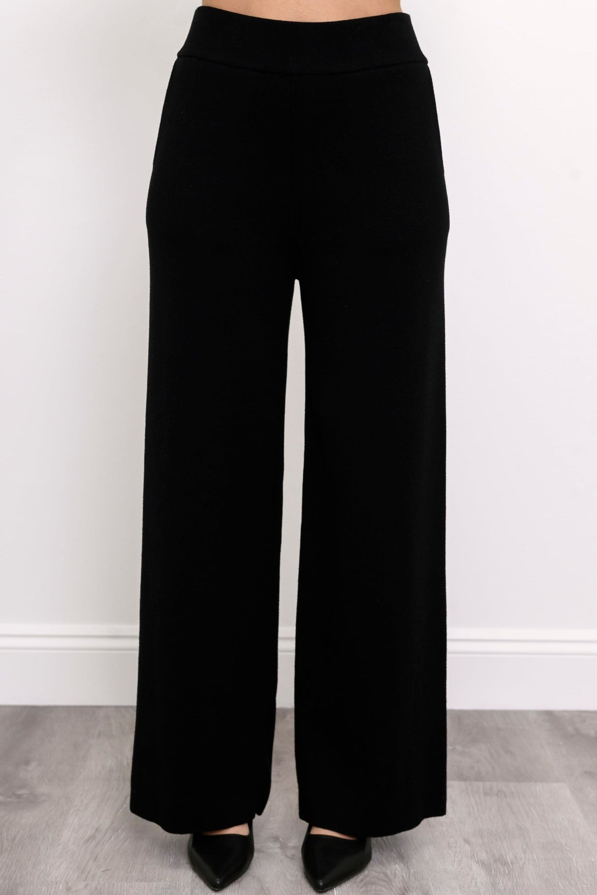 Comfortable onyx-colored pull-on pants showing side seam pockets and a fluid drape, shown on a white background.