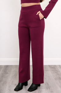 Side view of berry-toned pull-on pants on a model, highlighting the casual fit and straight-cut leg outline.
