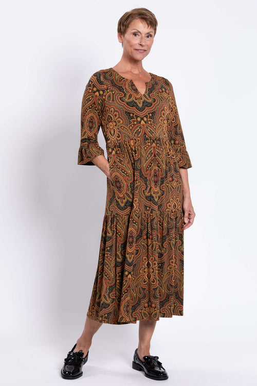 Woman wearing the Bernadette Long Dress in paisley print, front view