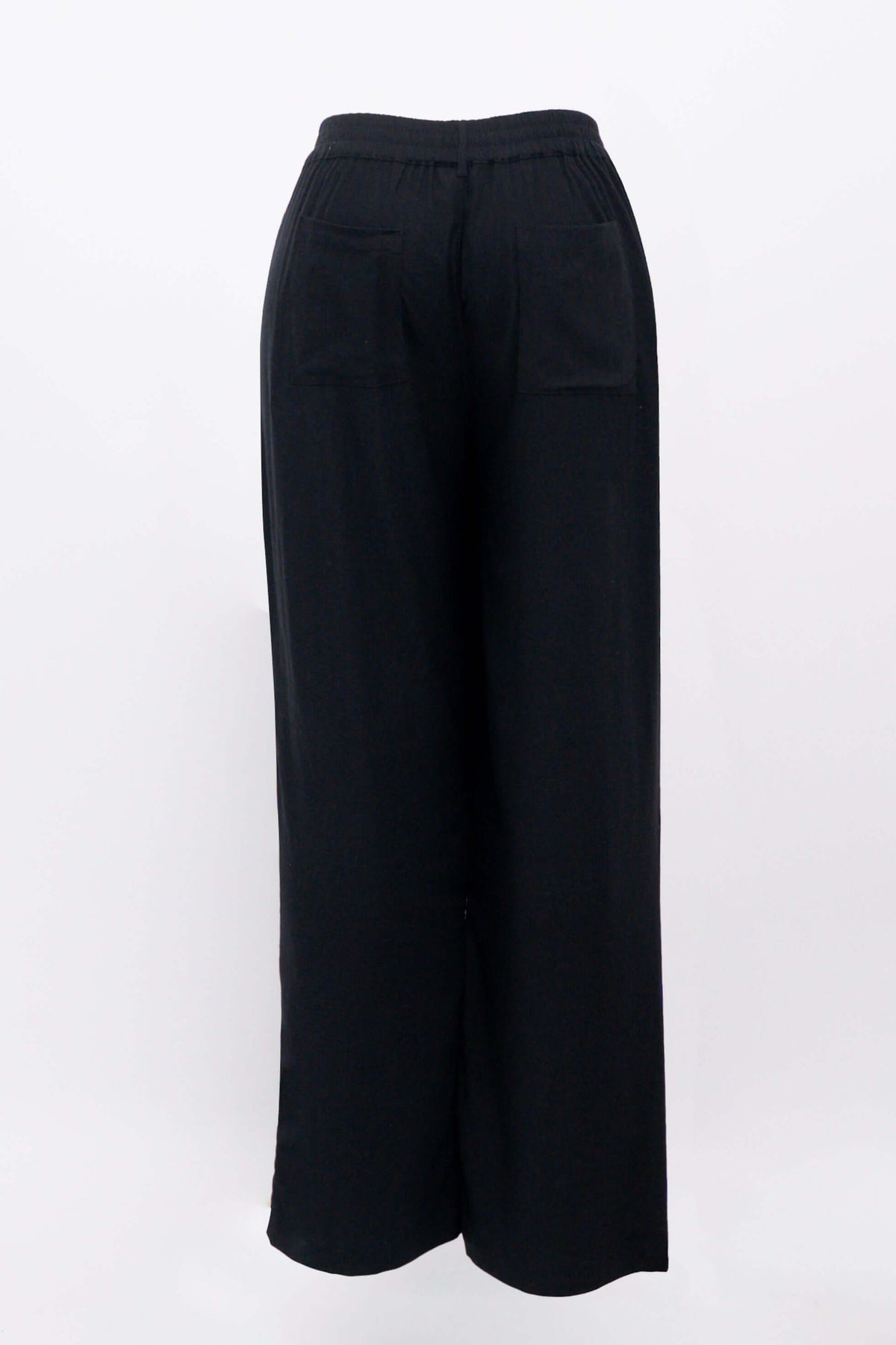 Black view of black trousers showing elastic waistband, pocket, and wide leg fits