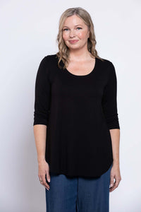 Woman in a black 3/4 sleeve bamboo top, smiling, front view