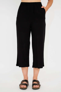 Black capri pants with model’s hand in pocket