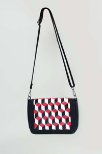 Black crossbody bag with red, white, and black geometric embroidered pattern