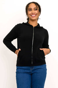 Woman wearing a black zip-front wool-cashmere hoodie with hands in pockets