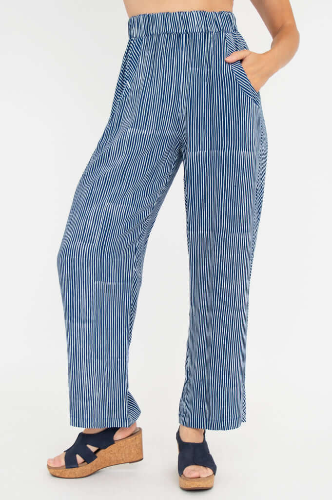 Woman wearing blue and white striped rayon pants with elastic waistband and side pockets