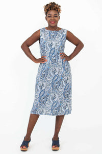 Woman posing in blue paisley shift dress, hands on hips