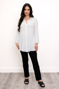 Full body front view of woman wearing a white collared blouse and slim black pants