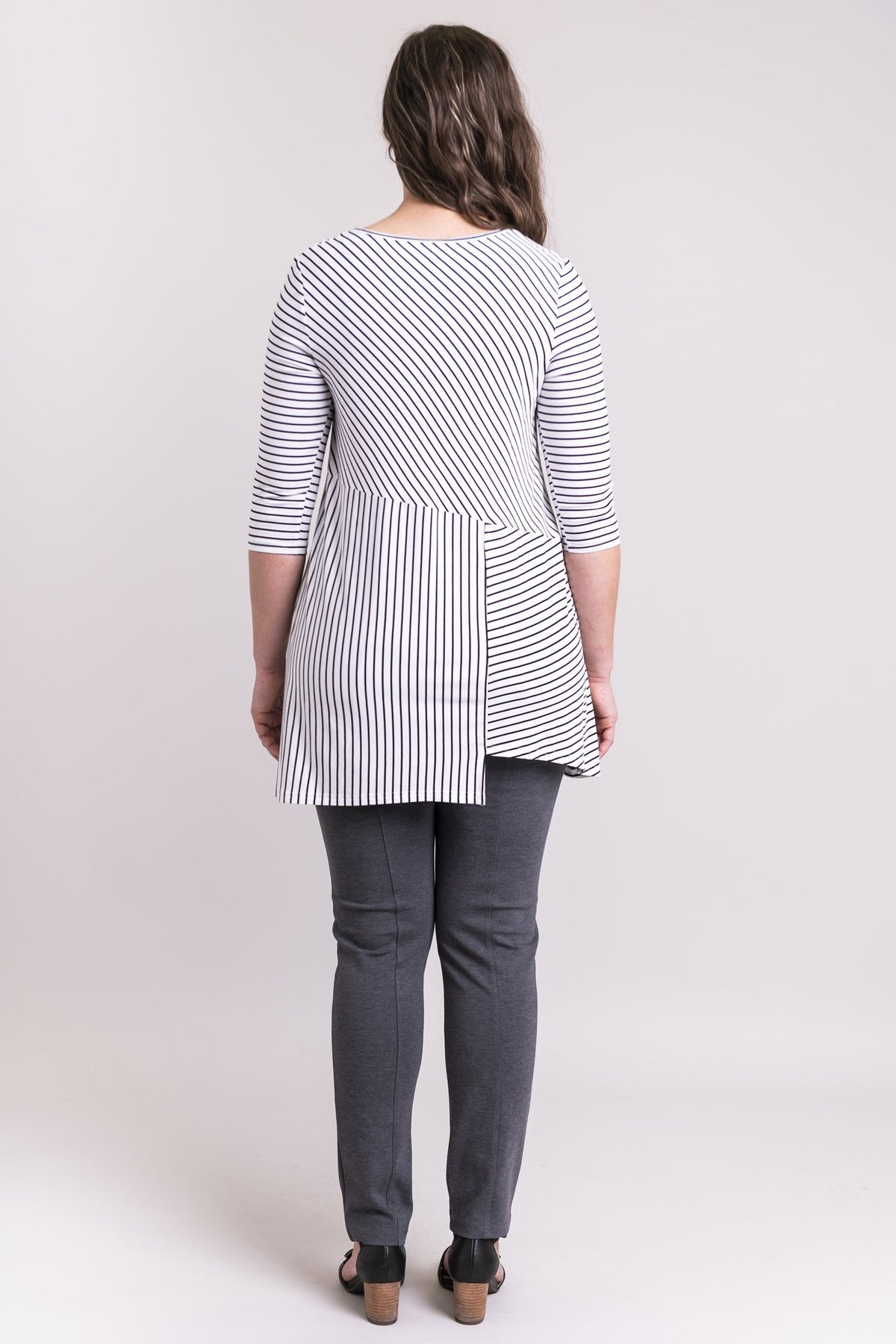 Women's black and white plus-size striped 3/4 sleeve tunic dress. Made with sustainable and fair-trade natural fibers. Back view.