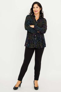 Model crossing arms while wearing Cindy smocked dot shirt and black pants