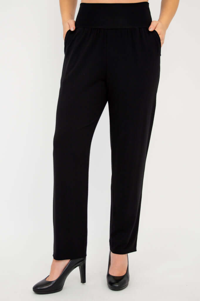 Clair bamboo pants in black, hands in deep pockets, wide waistband