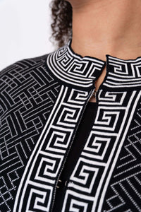 Close-up of the mandarin neck and front trim on a black and white geometric cardigan