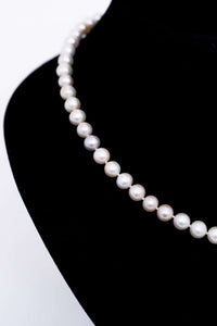 Close-up view of round cultured pearls on a necklace