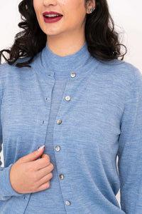 Close-up of ribbed neckline and buttons on blue Merino wool cardigan
