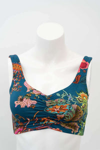 Close-up of teal floral crop top with cinched neckline on mannequin