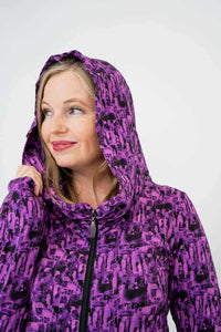 Woman wearing violet abstract hoodie with hood up, close-up view
