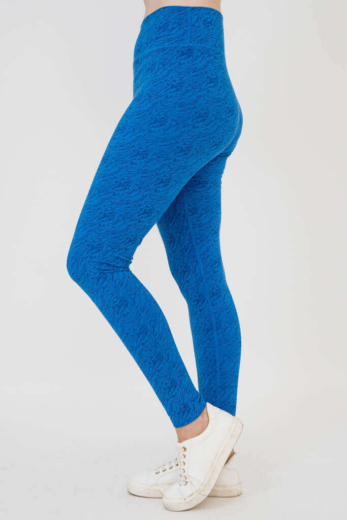 Model wearing cobalt blue Riley leggings, left side view