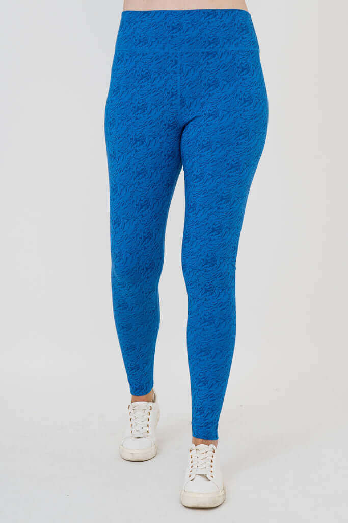 Model wearing cobalt blue Riley leggings, walking front view