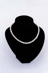 Cultured pearl necklace elegantly displayed on a black velvet bust
