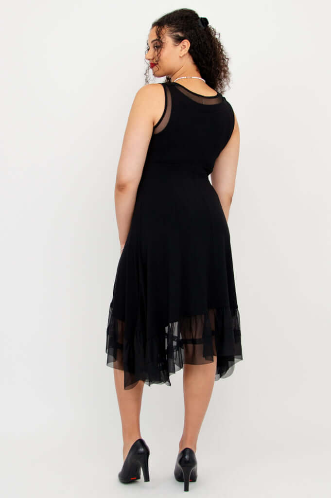 Back view of model wearing black sleeveless dress with mesh hem