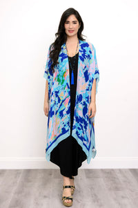 Front view of woman wearing a blue floral kimono on a black outfit against a white background
