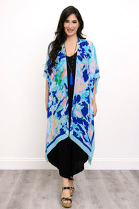 Front view of woman wearing a blue floral kimono on a black outfit against a white background