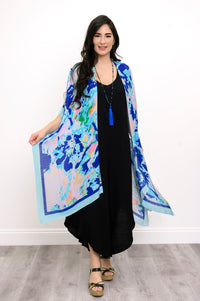 Front view of woman wearing a blue floral kimono on a black outfit against a white background