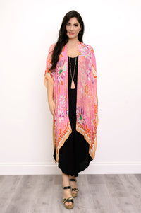 Front view of woman wearing a pink floral kimono on a black outfit against a white background