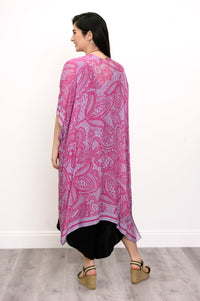 Back view of woman wearing pink and purple lace patterned kimono on a black outfit against a white background