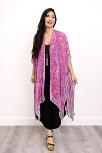 Front view of woman wearing pink and purple lace patterned kimono on a black outfit against a white background