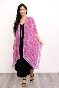 Front view of woman wearing pink and purple lace patterned kimono on a black outfit against a white background