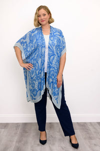 Front view of woman wearing blue lace patterned kimono on white and blue outfit against a white background 
