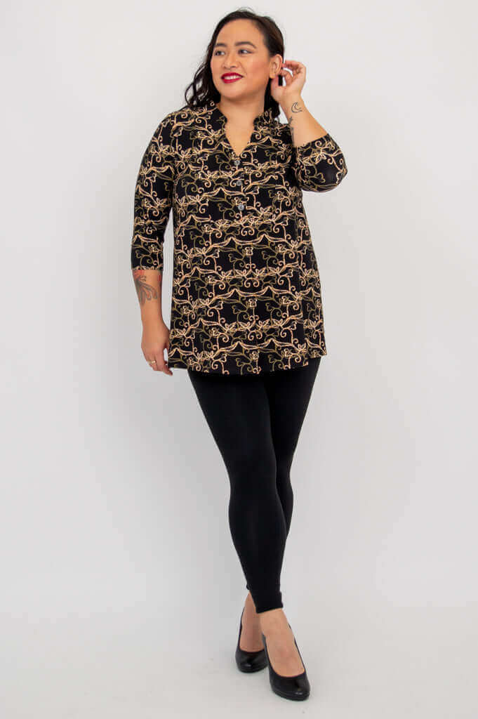 Woman wearing Edwina bamboo top and black leggings, looking to the side