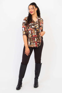 Model posing in Edwina bamboo top, western print, with hand at collar