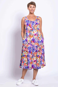 Woman showing side pockets on a colorful floral tank dress
