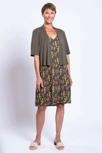 Woman in Felicia dress with olive cardigan, front view