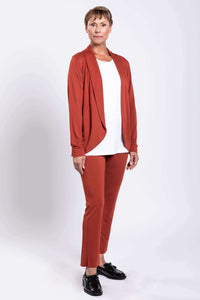 Woman posing in rust French Terry jacket and pants, side angle